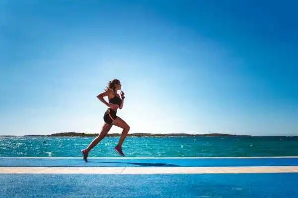 Woman running showing strong leg muscle Boston